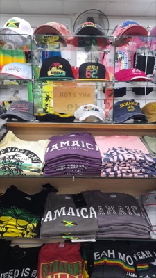 Display shelves of Jamaica caps and folded Good Vibes t-shirts