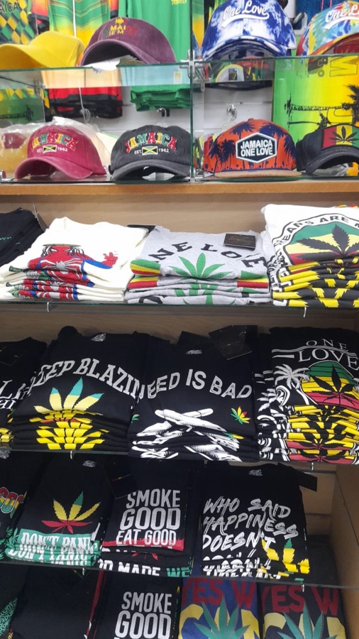 Shelves of Rasta-themed t-shirts and One Love graphic tees