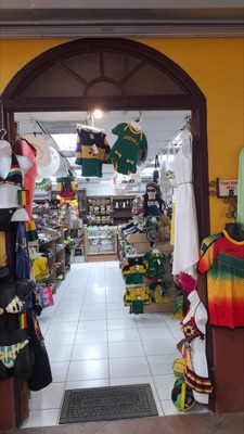 Welcome mat at the shop entrance with apparel on display