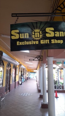 Sun 'n' Sand Exclusive Gift Shop storefront sign at Time Square Mall, Negril